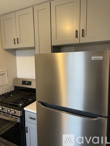 A stainless steel fridge with a logo on it.