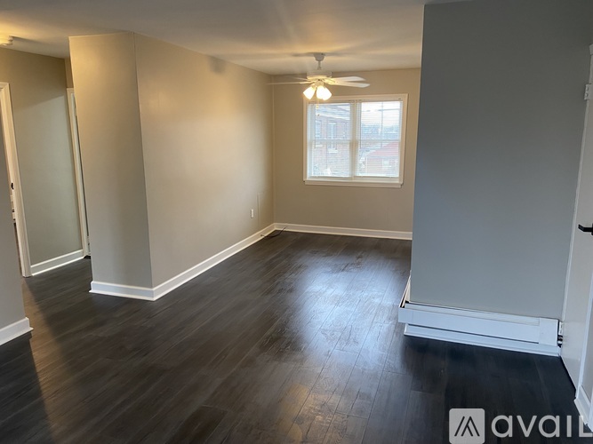 A room with a ceiling fan and a window.