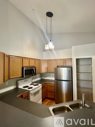 A kitchen with wooden cabinets and stainless steel appliances.