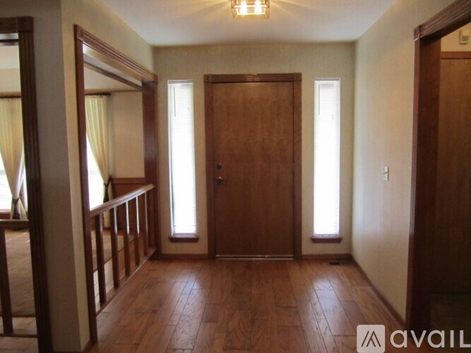 A room with wooden floors and a large mirror on the wall.