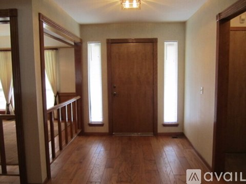A room with wooden floors and a large mirror on the wall.
