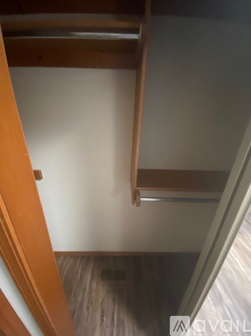 A wooden staircase with a metal railing.