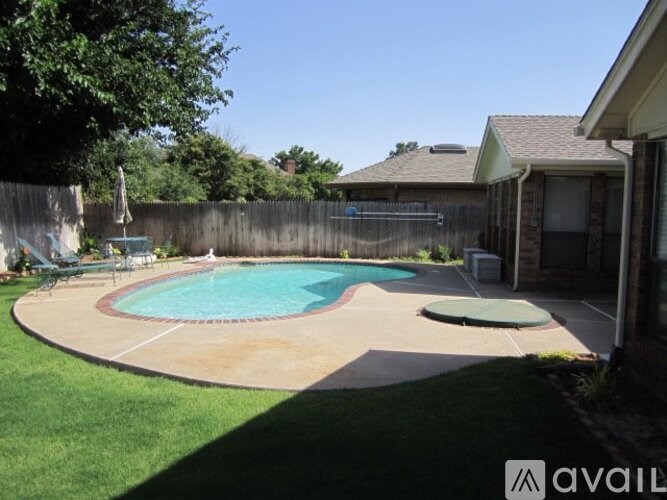 A backyard with a pool and a hot tub.