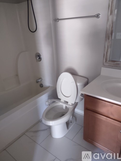 A white toilet in a bathroom with a copper sink.