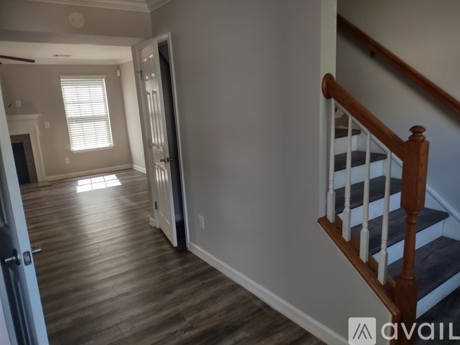 A hallway with a staircase leading to the second floor.