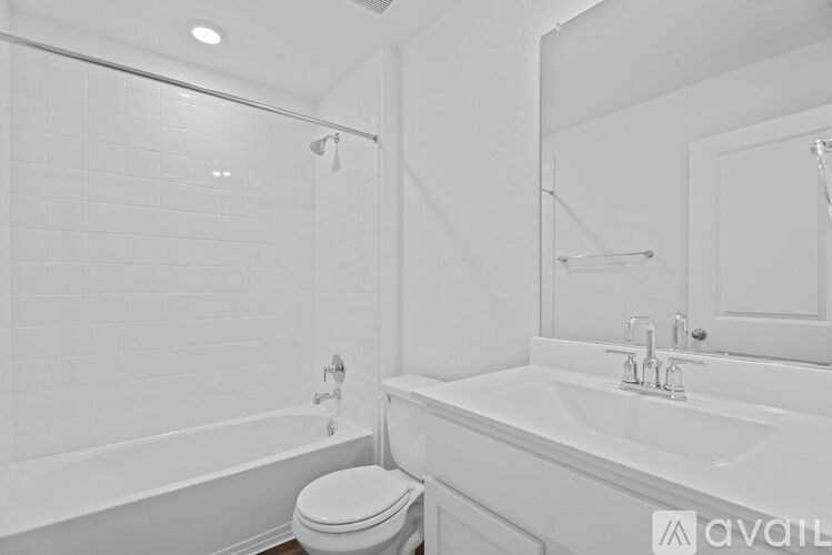 A white bathroom with a toilet, sink, and bathtub.