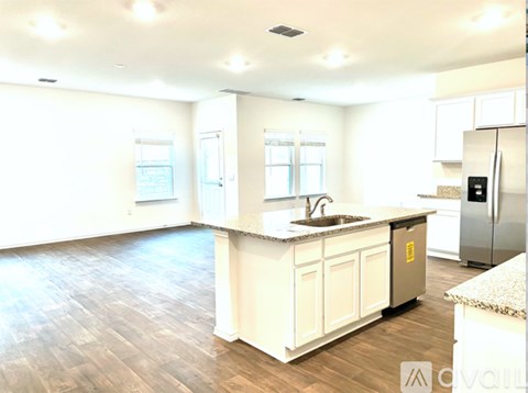 A kitchen with white cabinets and a sink.