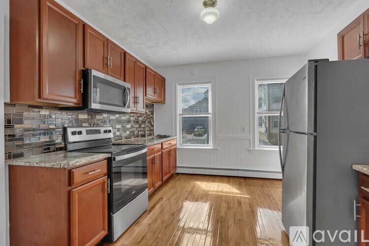 A kitchen with wooden cabinets and stainless steel appliances.