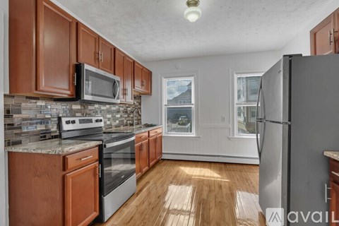 A kitchen with wooden cabinets and stainless steel appliances.