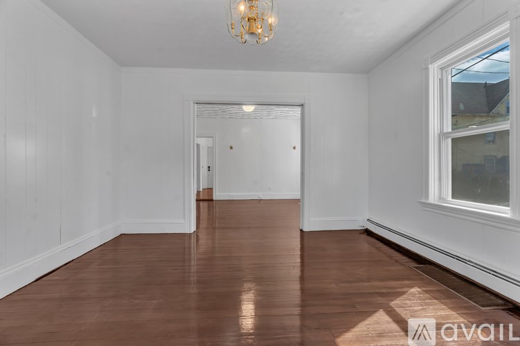 A room with wooden floors and white walls.