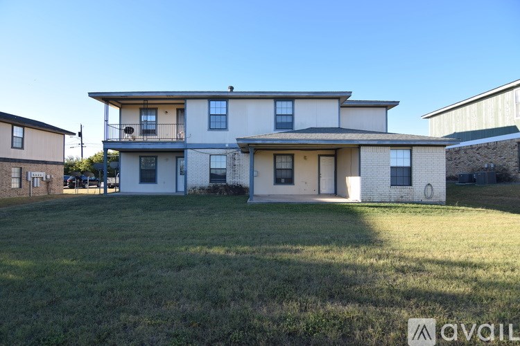 A two-story house with a balcony on the second floor.