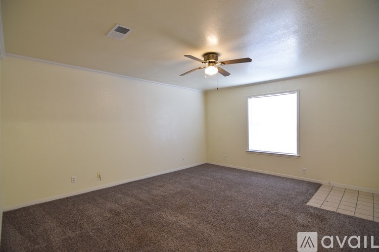 A room with a ceiling fan and a window.