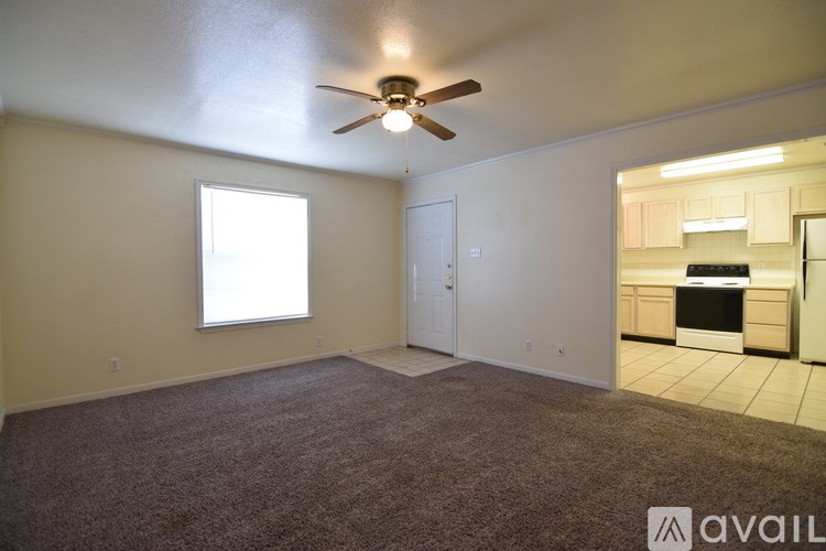 A room with a ceiling fan and a window.