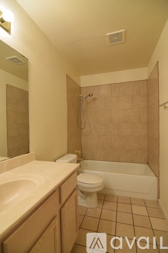 A bathroom with a toilet, sink, and bathtub.