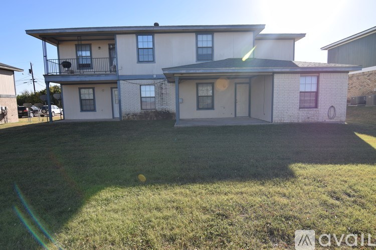 A two-story house with a balcony on the upper floor is for sale.