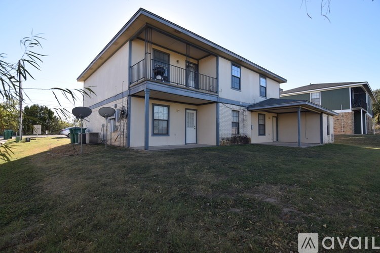 A two-story house with a balcony on the second floor.