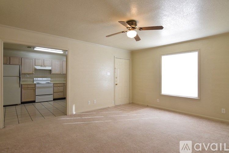 A room with a ceiling fan and a window.
