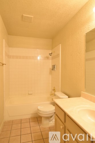A bathroom with a toilet, sink, and bathtub.