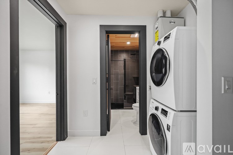 A cityscape at night with palm trees and buildings illuminated against a dark sky.