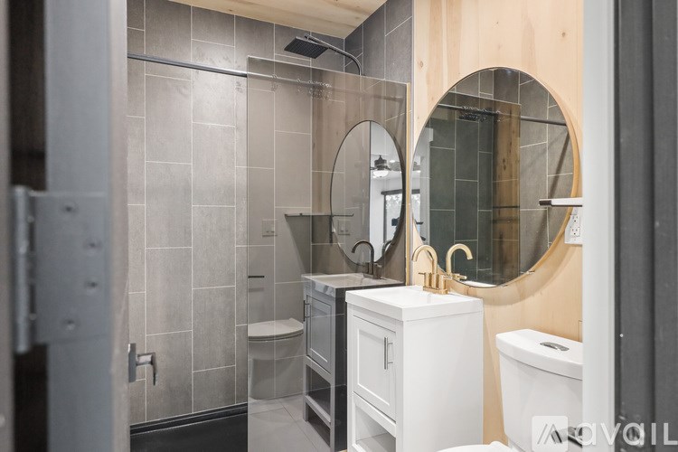 A bathroom with a toilet, sink, and shower.