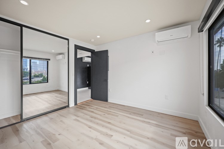 A bathroom with a sink, mirror, and wooden wall paneling.