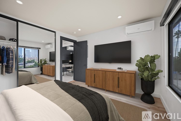 A modern two-story house with a balcony and stairs leading to the upper level.