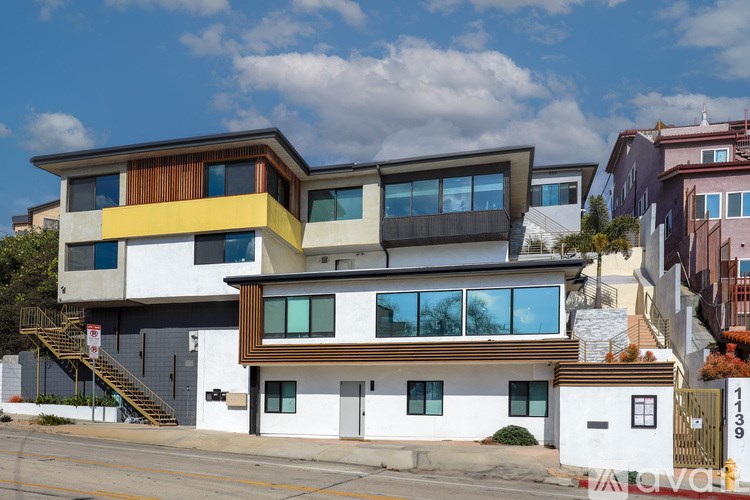 A modern two-story house with a white and brown exterior.