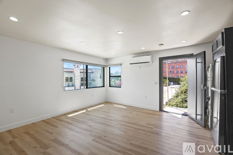 A modern two-story house with a balcony and stairs leading to the upper level.