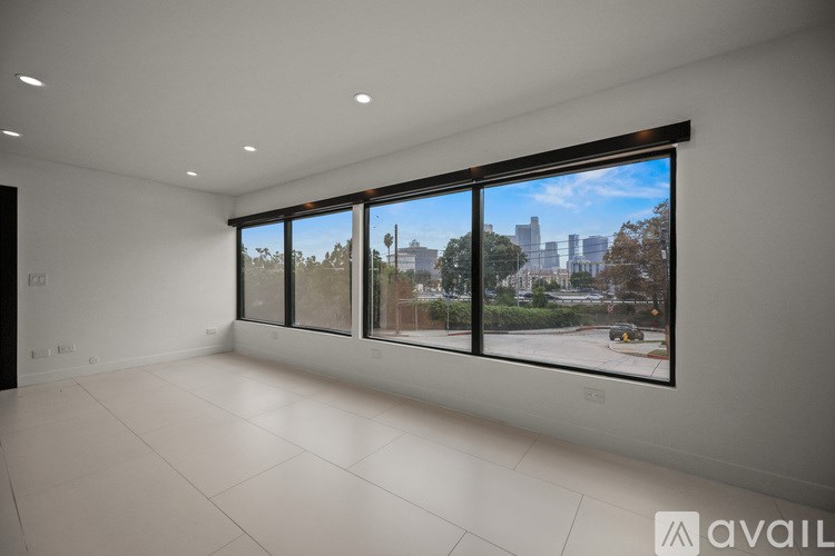 A modern multi-story house with a white base and yellow and brown accents.