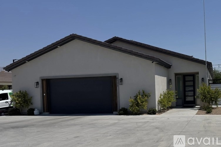 A house with a garage door is for sale.