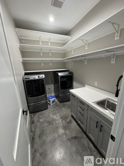 A small kitchen with a sink and two ovens.