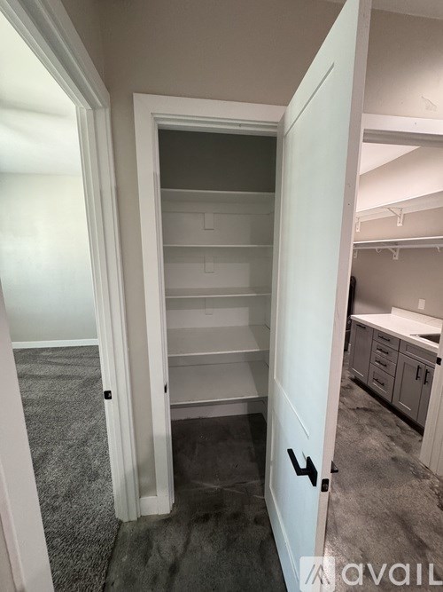 A white door with a black handle is open.