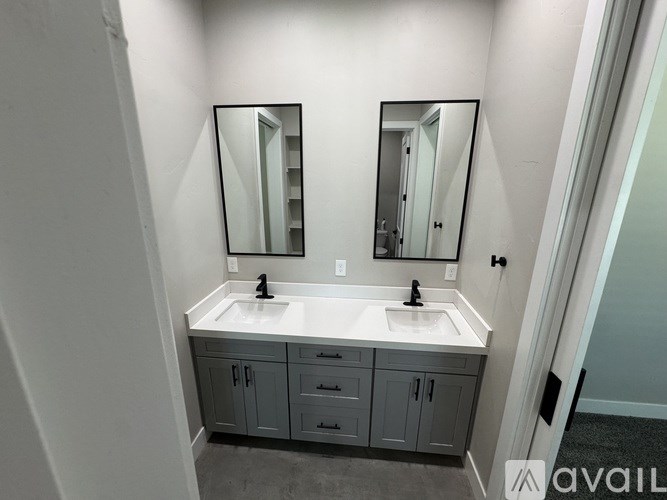 A bathroom with two sinks and two mirrors.