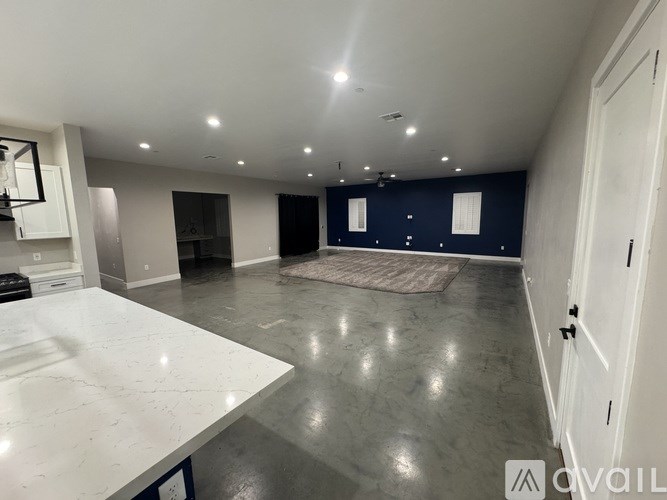 A spacious room with a white countertop and a rug on the floor.