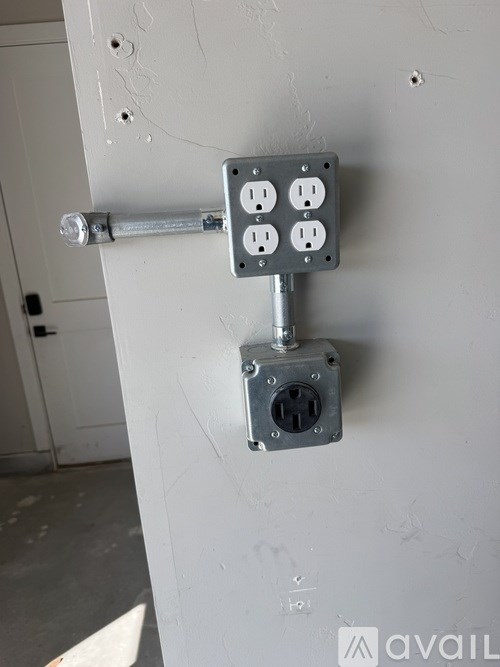 A grey electrical outlet box with a lever handle.