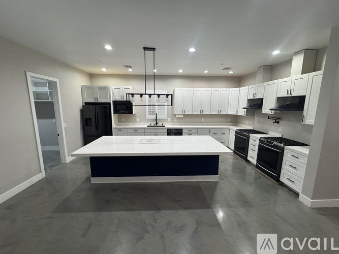 A modern kitchen with a large island in the center.