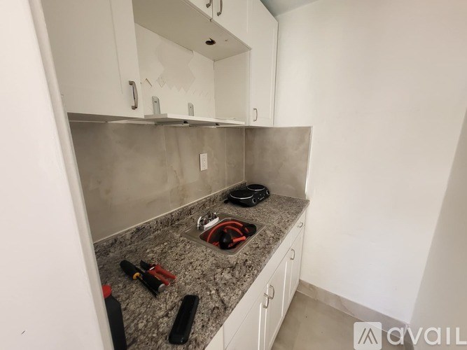 A kitchen counter with a red and black object on it.