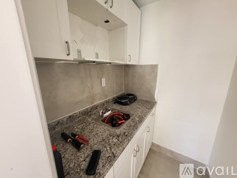 A kitchen counter with a red and black object on it.
