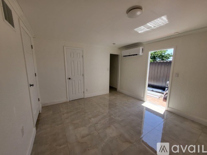 A room with a tiled floor and a ceiling light fixture.