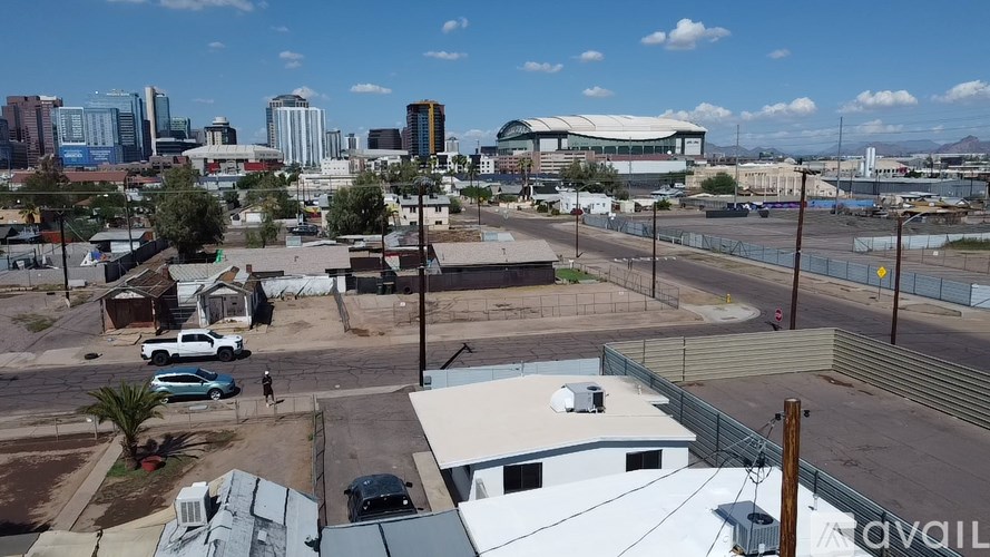 A cityscape with buildings and cars is visible from a high vantage point.