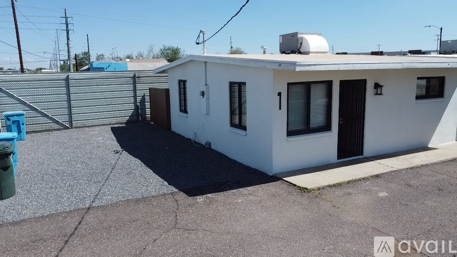 A white house with a blue mailbox is for sale.