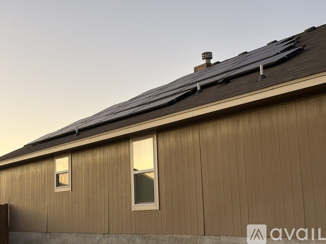 A living room with a couch, a fireplace, and a TV mounted on the wall.