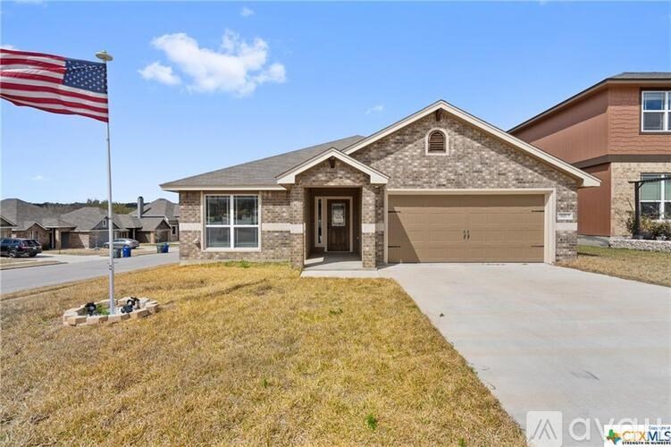 A house with a flag on the lawn.