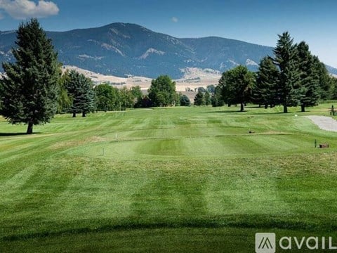 A golf course with a mountain in the background.