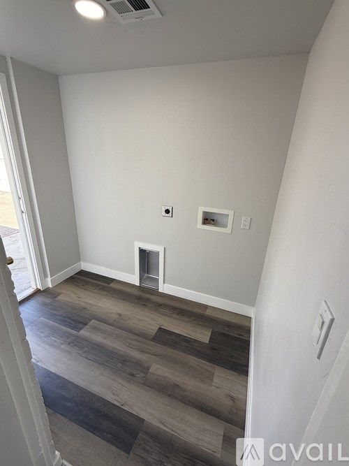 A room with a fireplace and a wooden floor.