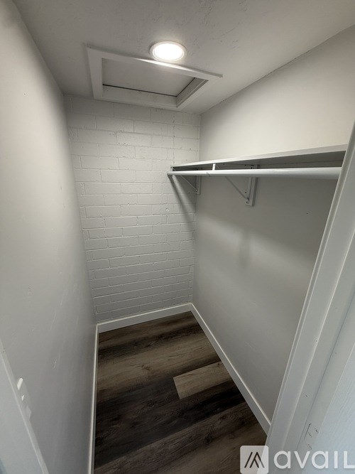 A stairway with a white wall and wooden steps.