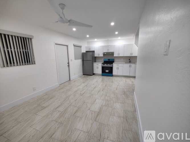 A room with a ceiling fan and a cabinet.