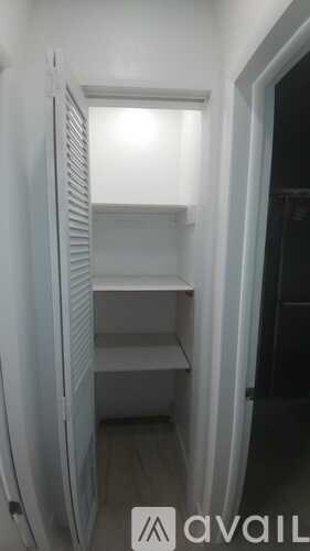 A white refrigerator with a shelves inside.