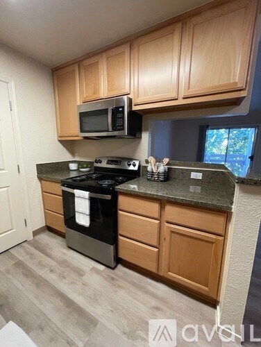 A bathroom sink with a granite countertop and a mirror above it.