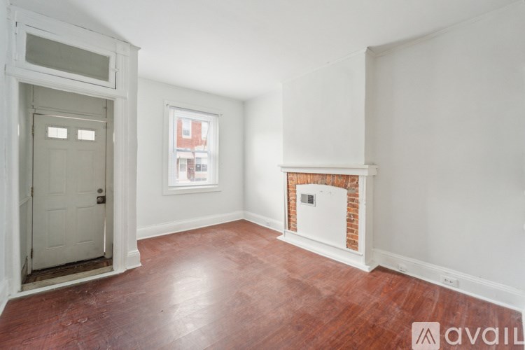 A room with a fireplace and a door.